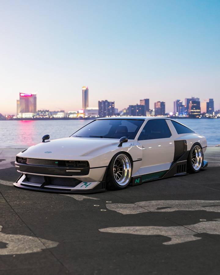 A digital render of a white Hyundai N Vision 74 on a waterfront, with a city skyline across the water behind it.