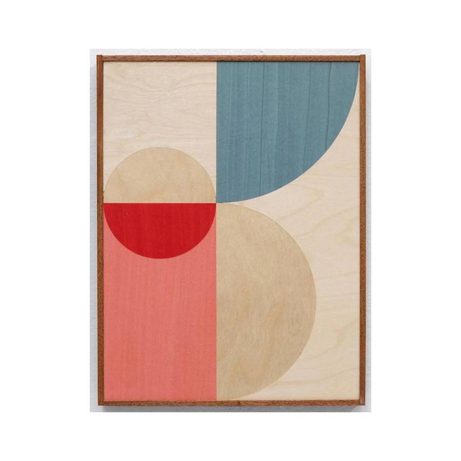 A framed panel of overlapping circles and rectangles in bare wood, teal, coral and red.