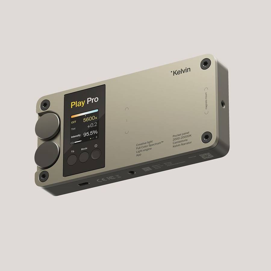 A pocket light panel with an aluminium body, two round knobs and a screen showing colour temperature and intensity readings, on a plain grey ground.