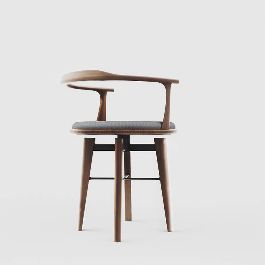A timber armchair with a curved back rail and arms, a grey upholstered seat, tapered legs and black stretchers, on a plain pale grey ground.
