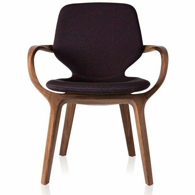 A chair with a timber frame, sculpted arms that curve down to the front legs and a dark purple upholstered seat and back, on a white ground.