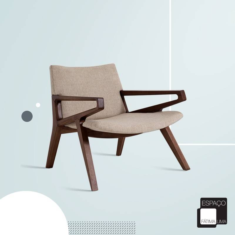 An armchair with a dark timber frame and a beige upholstered back and seat, cut out over a pale blue background with circles, a dotted panel and a shop logo in the lower corner.
